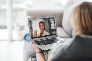 patient at home on a video call with her doctor
